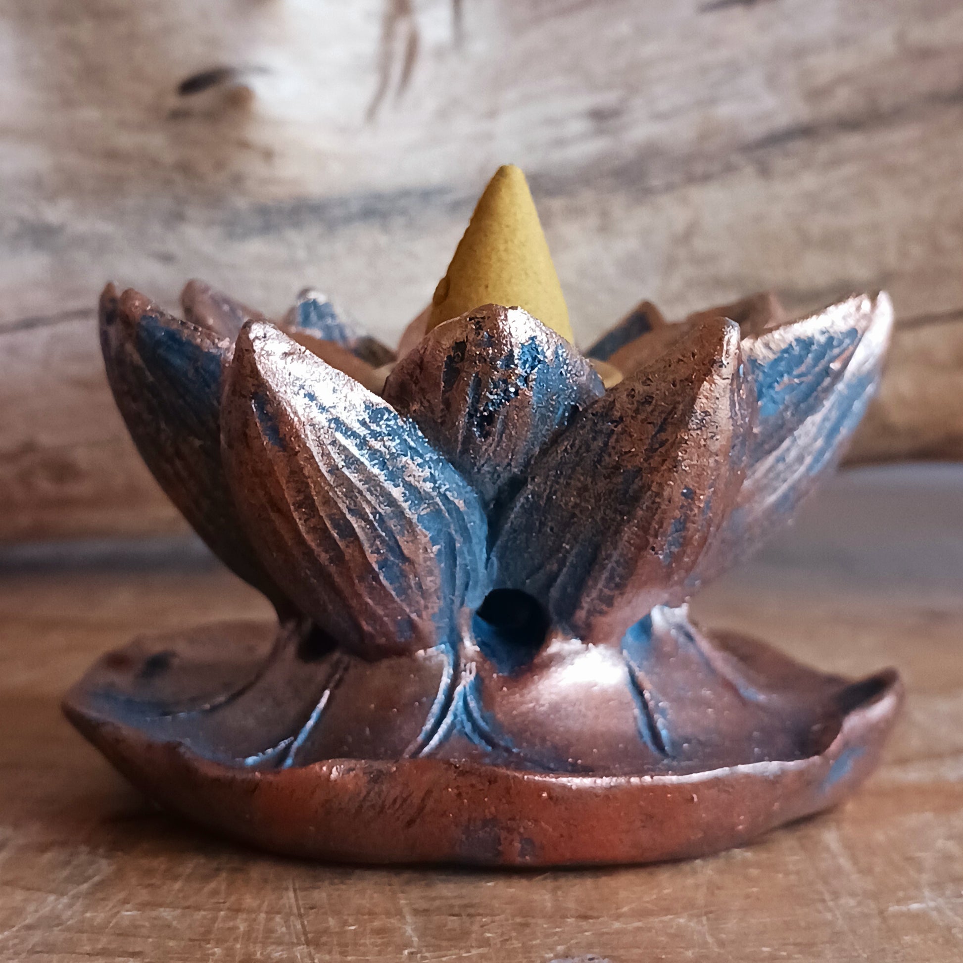 Backflow incense burner in a bronze lotus flower design. When the cone is lit the smoke from the cone cascades downwards in a mesmerizing waterfall effect to pool at the bottom. Beautiful to watch.