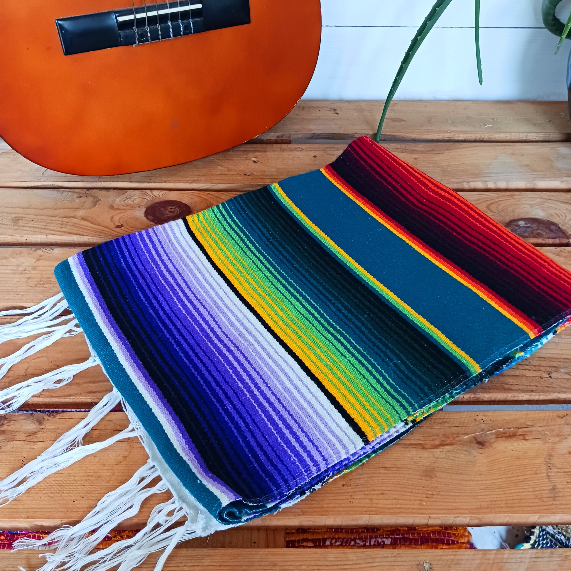 Bring bold colour and cultural charm into your space with our Mexican Serape Vibrant Green Blanket. Inspired by traditional Mexican festival textiles, this eye-catching throw features striking tones and classic serape stripes that instantly brighten any room.