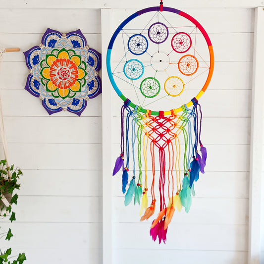 Bring harmony, colour, and positive energy into your space with this large, vibrant dreamcatcher. Featuring seven small hoops representing each of the chakras, this stunning piece is hand-crafted with bright rainbow crocheting. Ideal as a wall hanging, it makes a thoughtful gift for yoga lovers, meditation enthusiasts, or anyone seeking balance and wellbeing. Perfect for adding a spiritual touch to your home décor while promoting peace and positivity.