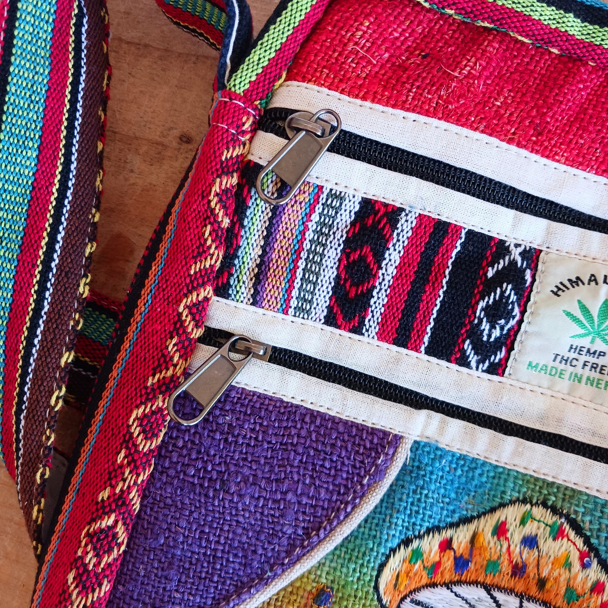 This is such a fantastic and handy messenger bag or satchel. Made from hemp with cotton lining, this bag is beautifully crafted featuring lots of handy compartments. On the front are three colourful and embroidered mushrooms.
