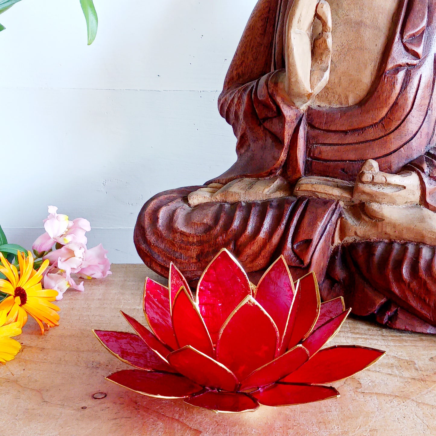 Illuminate your space with the peaceful elegance of our Capiz Shell Lotus Flower Candle Holder. Symbolizing enlightenment and serenity, this stunning handcrafted piece features delicate red petals edged in gold, forming the iconic lotus shape. 