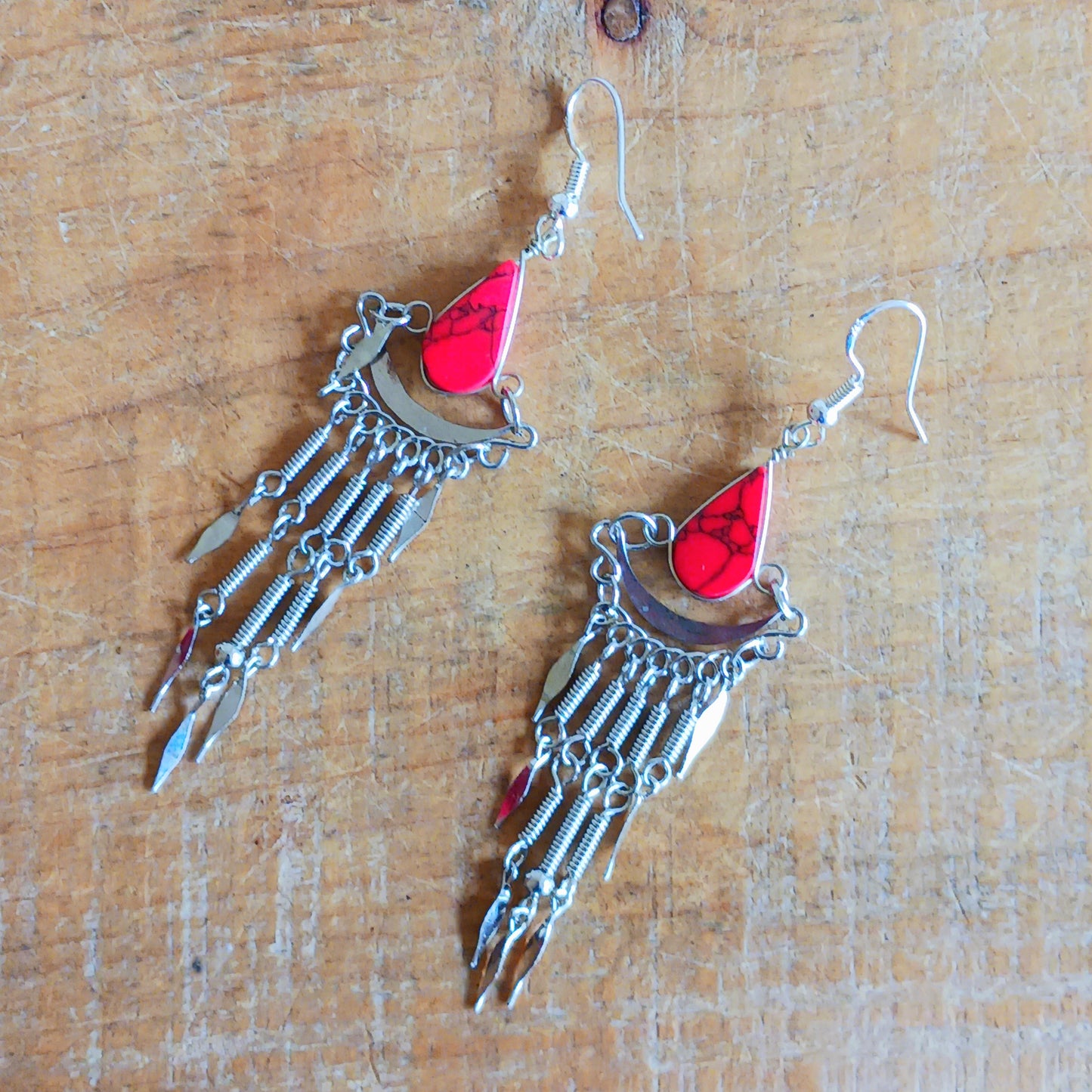 Add a touch of bohemian beauty to your look with these handmade Peruvian stone earrings. Featuring red stones and finished with silver-plated hooks, each pair is carefully crafted in small workshops in Peru.