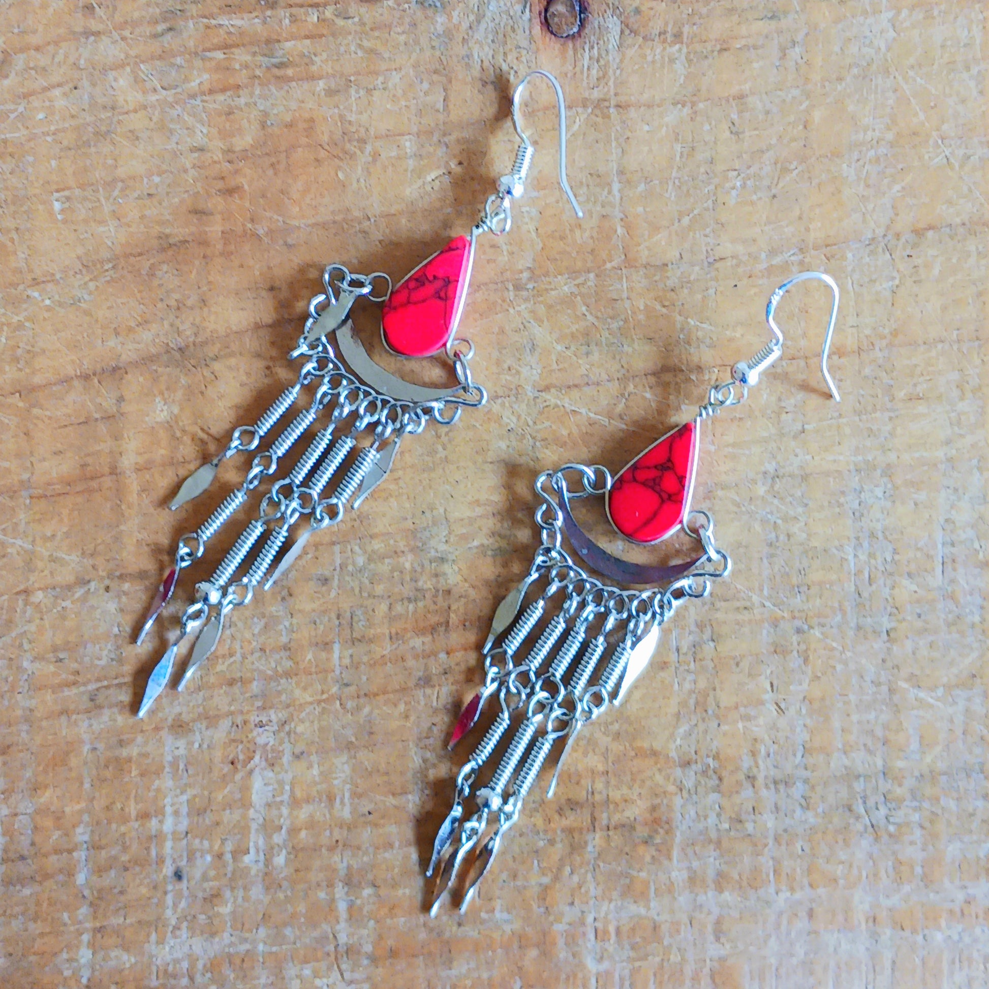 Add a touch of bohemian beauty to your look with these handmade Peruvian stone earrings. Featuring red stones and finished with silver-plated hooks, each pair is carefully crafted in small workshops in Peru.
