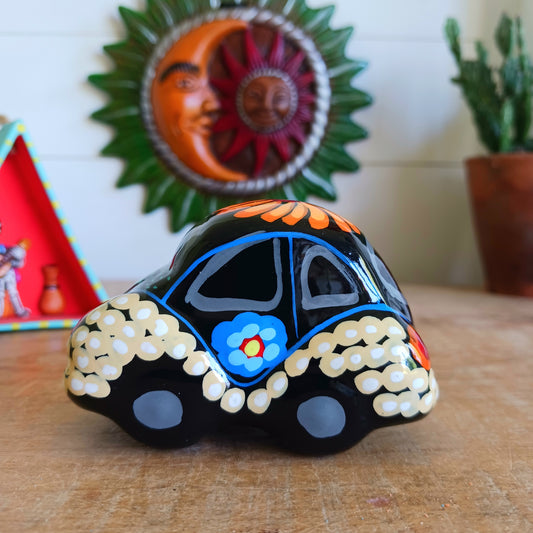 This fun little VW car ornament oozes retro vibes.  With it's bold flower power design and vibrant colours it will brighten up any sideboard.  This type of car, affectionately known as a 'bochito', are very popular in Mexico due to their reliability when driving about steep roads. Incidentally, the Mexican town of Puebla was home to the last Beetle production factory which only closed in 2003.