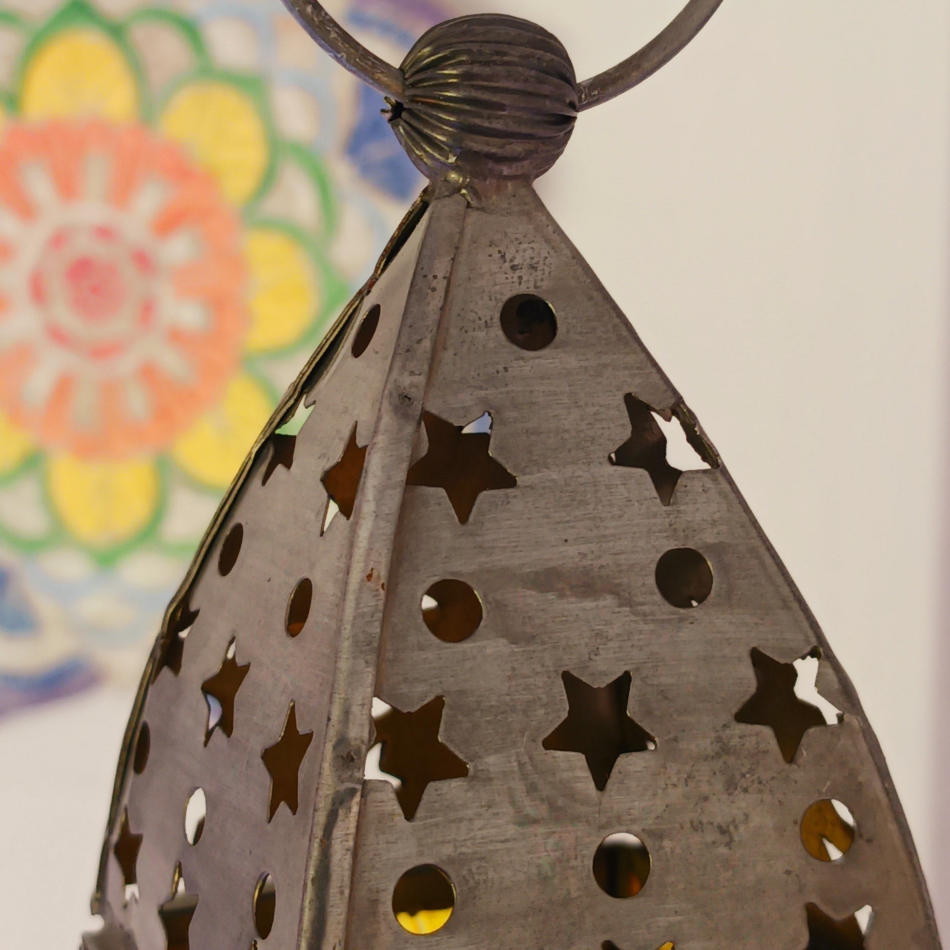 Bring warmth, colour and spiritual harmony to your home with this beautiful Tree of Life Glass Lantern. Designed with vibrant coloured glass panels and a decorative metal cut-out canopy, this lantern creates a calming glow that enhances meditation spaces, yoga rooms and home décor.