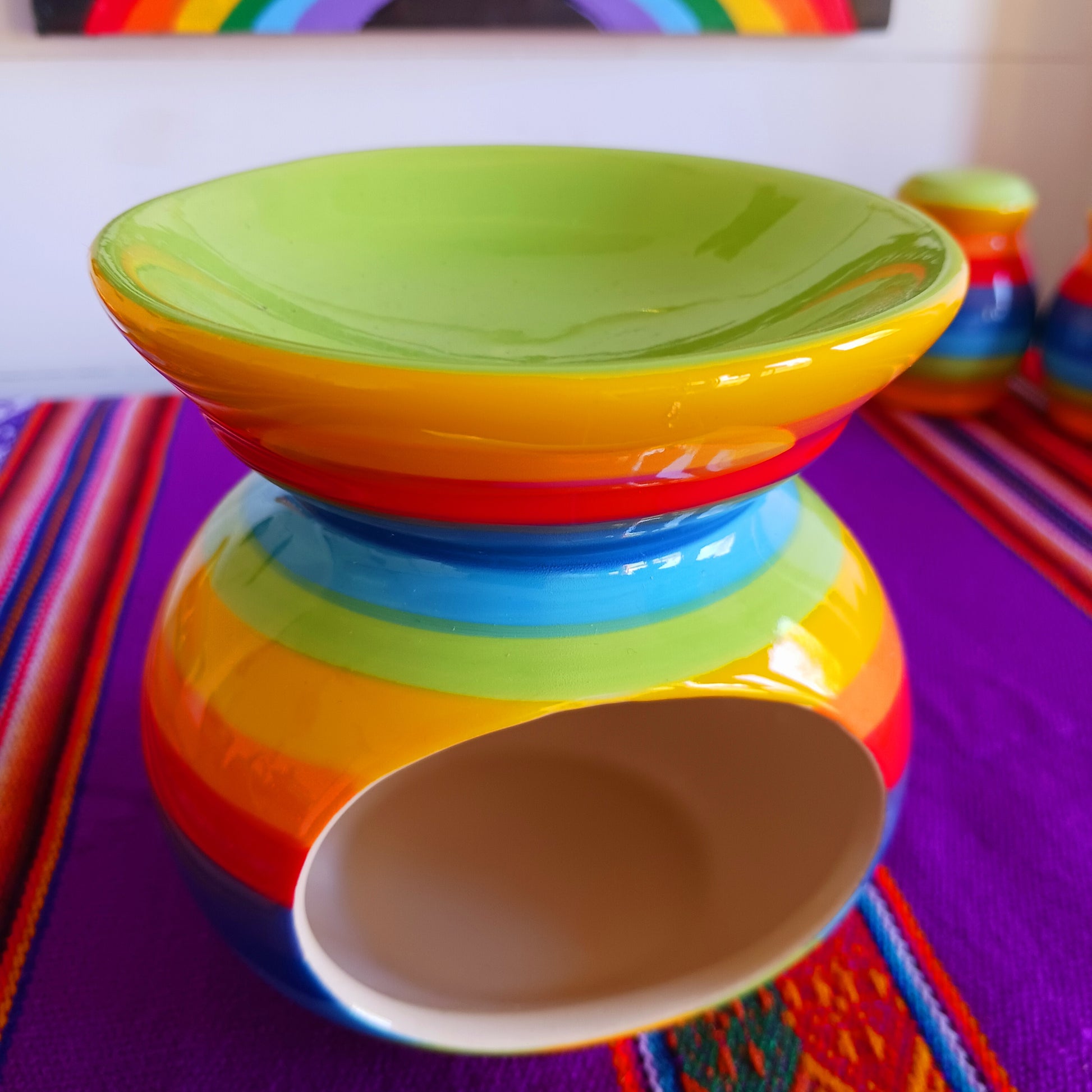 Wonderfully cheerful rainbow stripe ceramic oil burner. The vibrant stripes are hand painted giving each piece individual character.