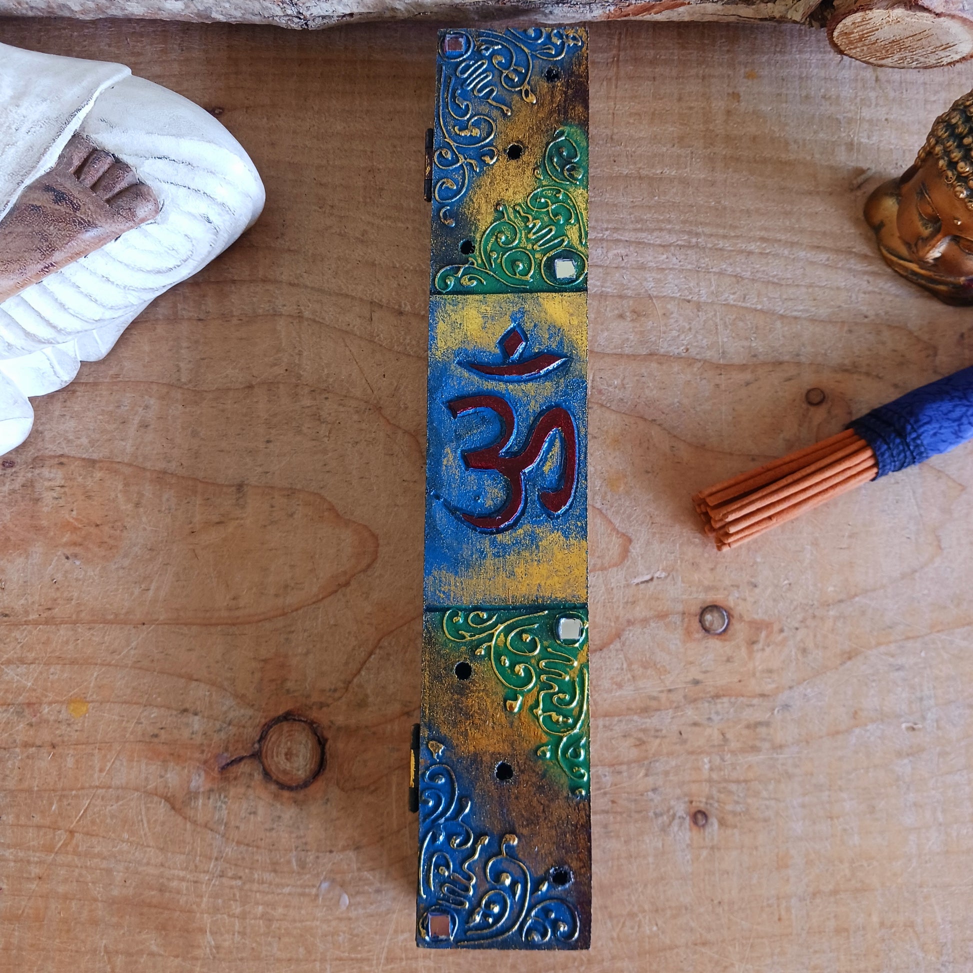 This unique incense stick holder is perfect to catch the ash from your favourite incense. It has been handmade from responsibly sourced wood, skillfully carved and decorated with a centre OM symbol.