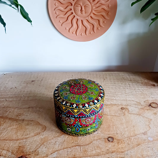 Add a touch of artisan charm to your home with this beautifully hand painted round wooden lidded box, featuring intricate patterns in vibrant colours. Carefully handcrafted in India, each decorative box is uniquely detailed, making it a truly special keepsake.