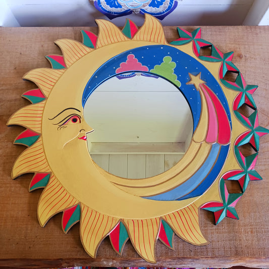 Bring the cosmos into your home with this beautifully handcrafted Sky Mirror, a unique and stunning wooden mirror adorned with intricate carvings of the sun, moon, and stars. Each piece is meticulously created by skilled artisans, ensuring fairtrade practices and exceptional quality. This celestial-inspired décor adds warmth, character, and a mystical charm to any room — perfect for those who love unique, meaningful home accents.