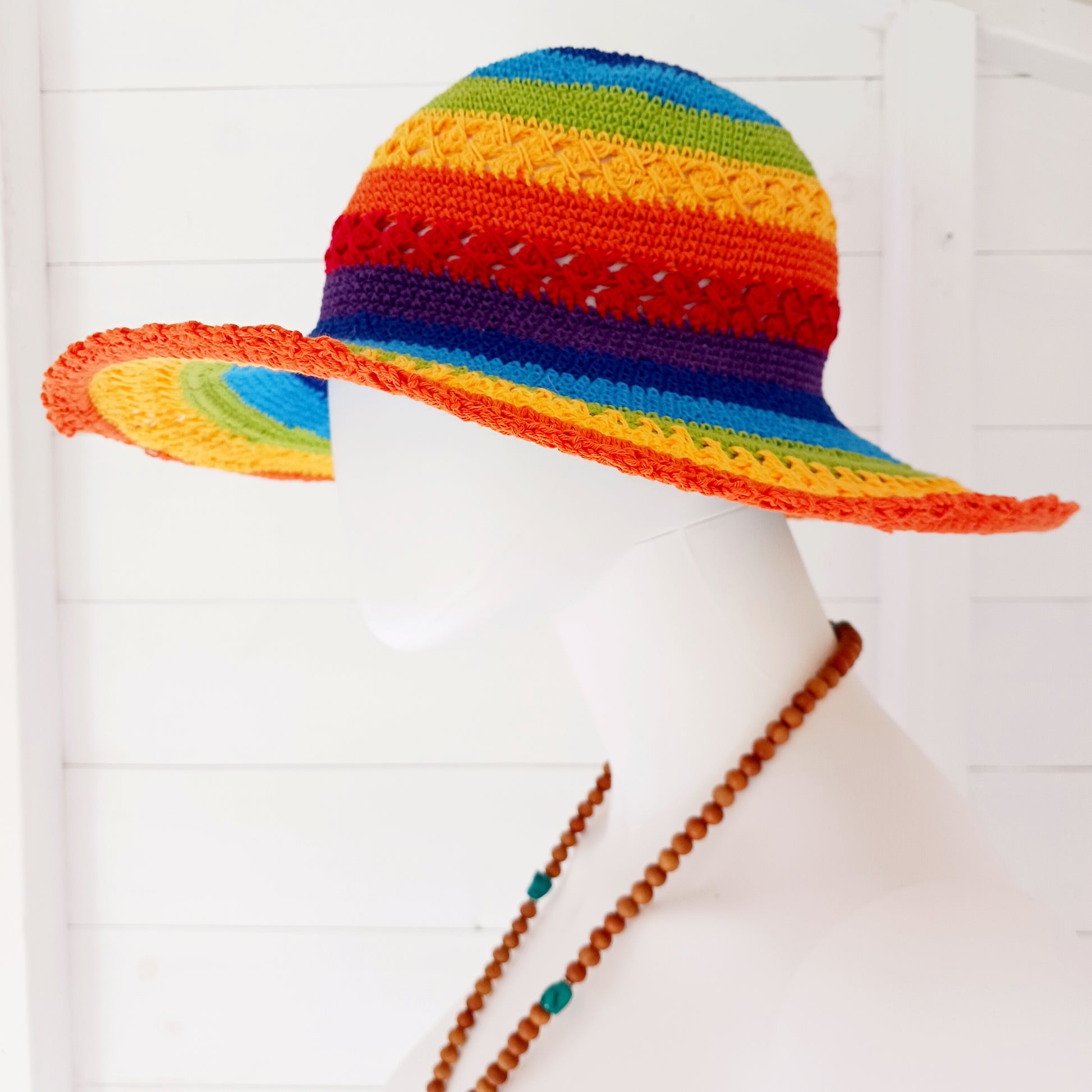 Brighten up your summer with this vibrant handmade crochet cotton sun hat! Featuring a stunning rainbow pattern, this unique hat is perfect for holidays, beach days, and festivals. A malleable wire is carefully woven into the rim, allowing you to shape the brim just how you like it. Lightweight and breathable, it's ideal for sunny adventures. Each hat is individually handcrafted, so you’ll receive the exact one pictured – a one-of-a-kind accessory to celebrate the season in style.