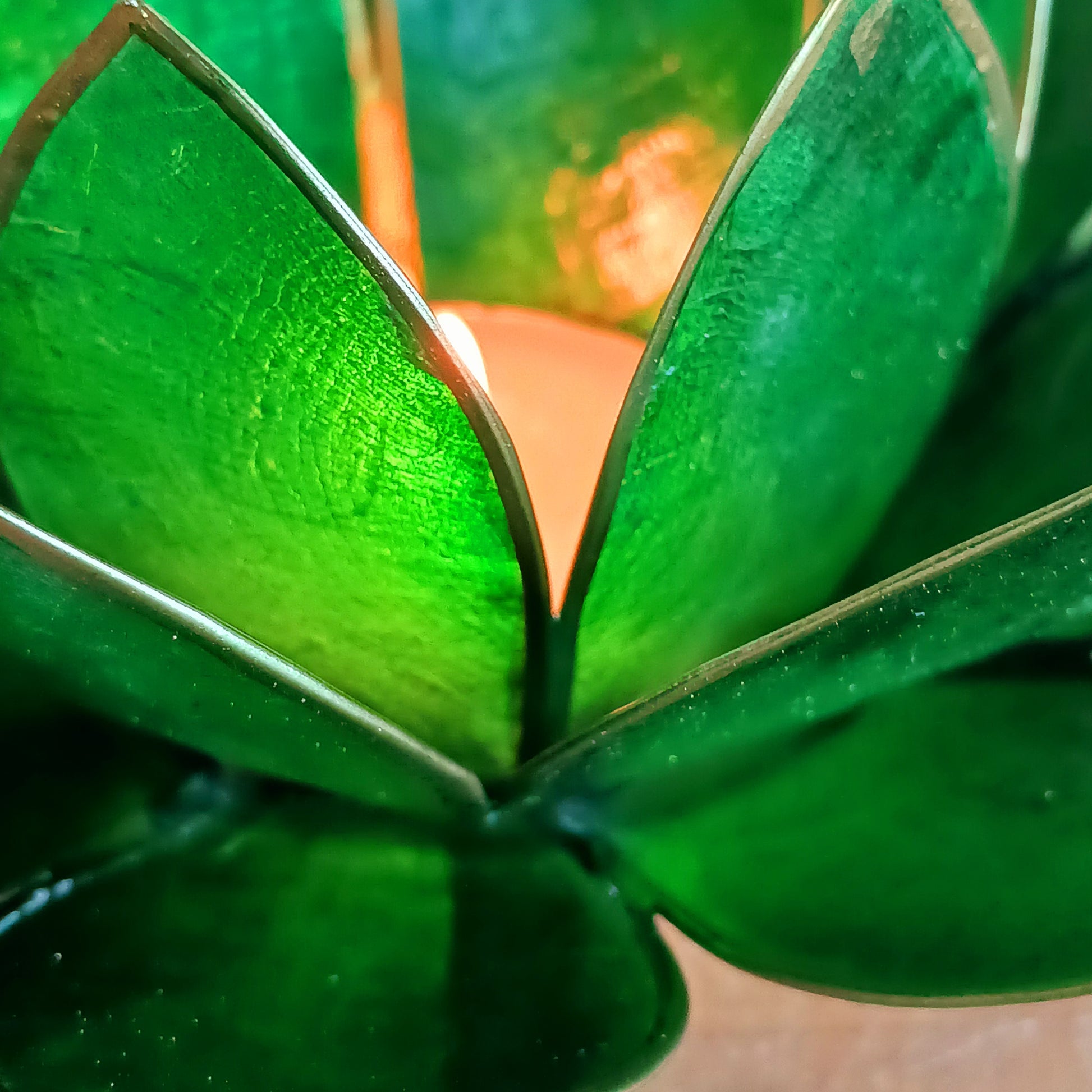 Illuminate your space with the peaceful elegance of our Capiz Shell Lotus Flower Candle Holder. Symbolizing enlightenment and serenity, this stunning handcrafted piece features delicate green petals edged in gold, forming the iconic lotus shape.