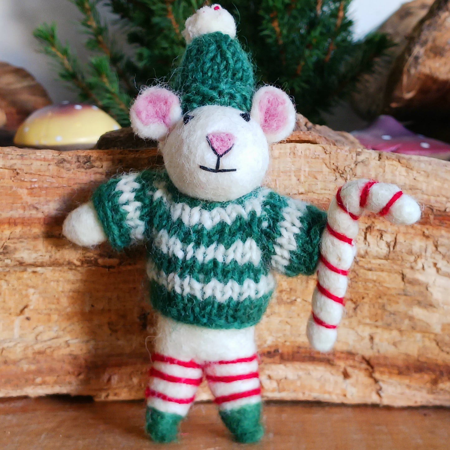 Meet our endearing little Christmas mice, dressed in vibrant elf knitwear, joyfully clutching a felt candy cane ready to spread festive cheer. Each ornament is lovingly handcrafted, capturing the magic and childlike wonder of the holiday season.