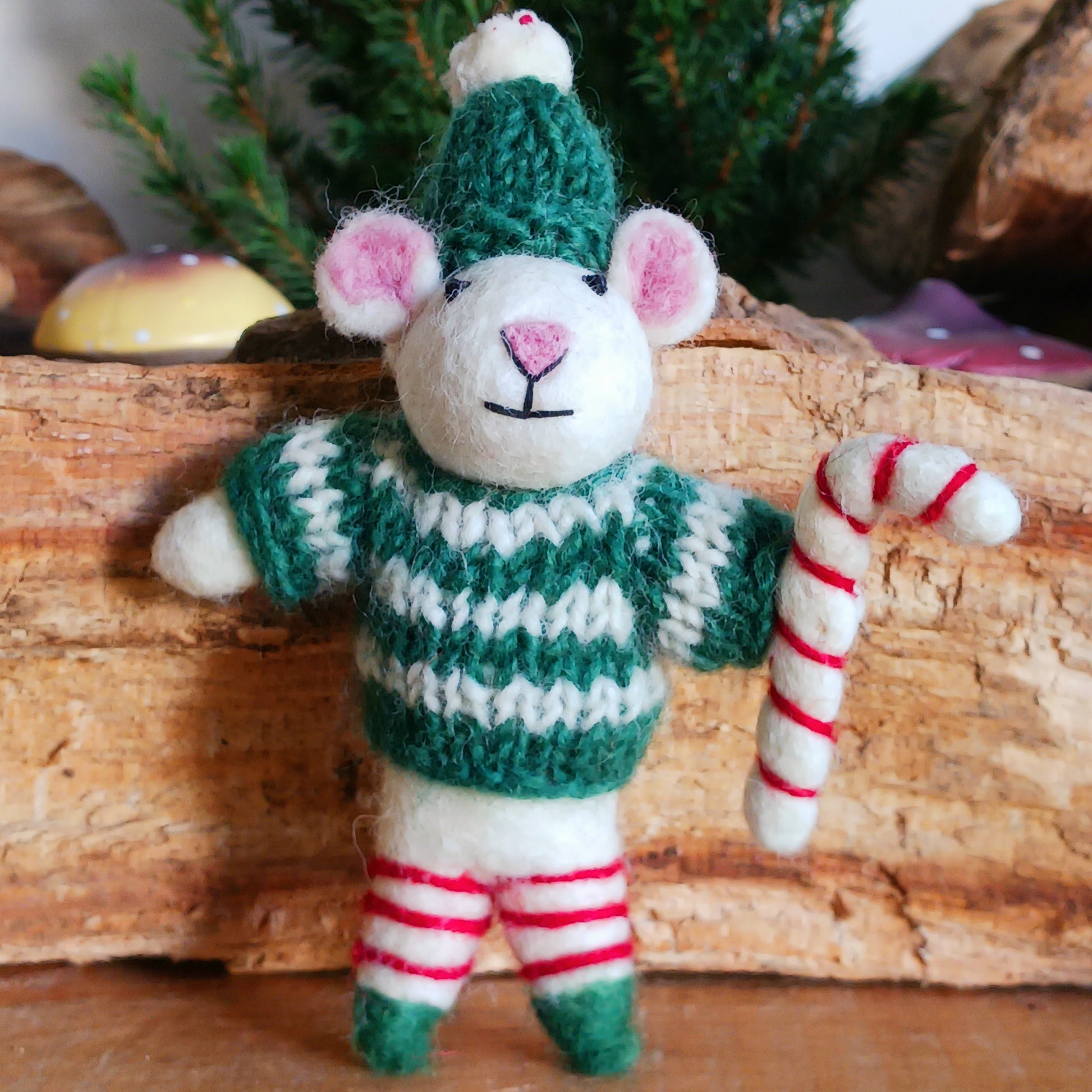 Meet our endearing little Christmas mice, dressed in vibrant elf knitwear, joyfully clutching a felt candy cane ready to spread festive cheer. Each ornament is lovingly handcrafted, capturing the magic and childlike wonder of the holiday season.