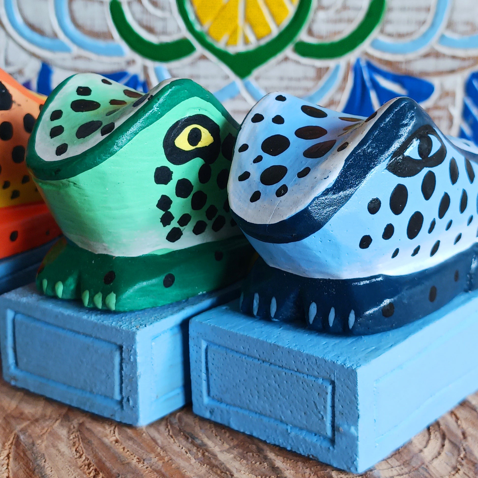 Bring charm and character into your home with this decorative wooden door stopper, featuring a turquoise base and a playful, hand-painted dotty frog design in vibrant blue, green, and orange. Perfect for propping open doors in style, this quirky wedge door stop is both practical and fun.