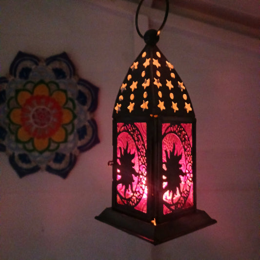 Bring warmth, colour and spiritual harmony to your home with this beautiful Sun & Moon Glass Lantern. Designed with vibrant coloured glass panels and a decorative metal cut-out canopy, this lantern creates a calming glow that enhances meditation spaces, yoga rooms and home décor.