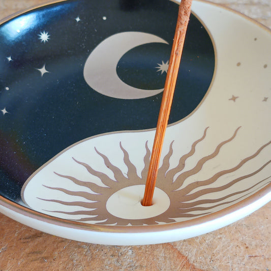 Bring harmony and calm to your space with our Celestial Yin Yang Incense Holder Dish. Crafted with a peaceful celestial design, this incense dish is perfect for holding your favourite calming scents. Whether you're meditating, practicing yoga, or simply unwinding after a long day, this elegant piece adds a serene touch to your zen oasis. Designed to catch ash neatly while enhancing your décor, it’s both functional and beautiful. Ideal for any mindful moment.