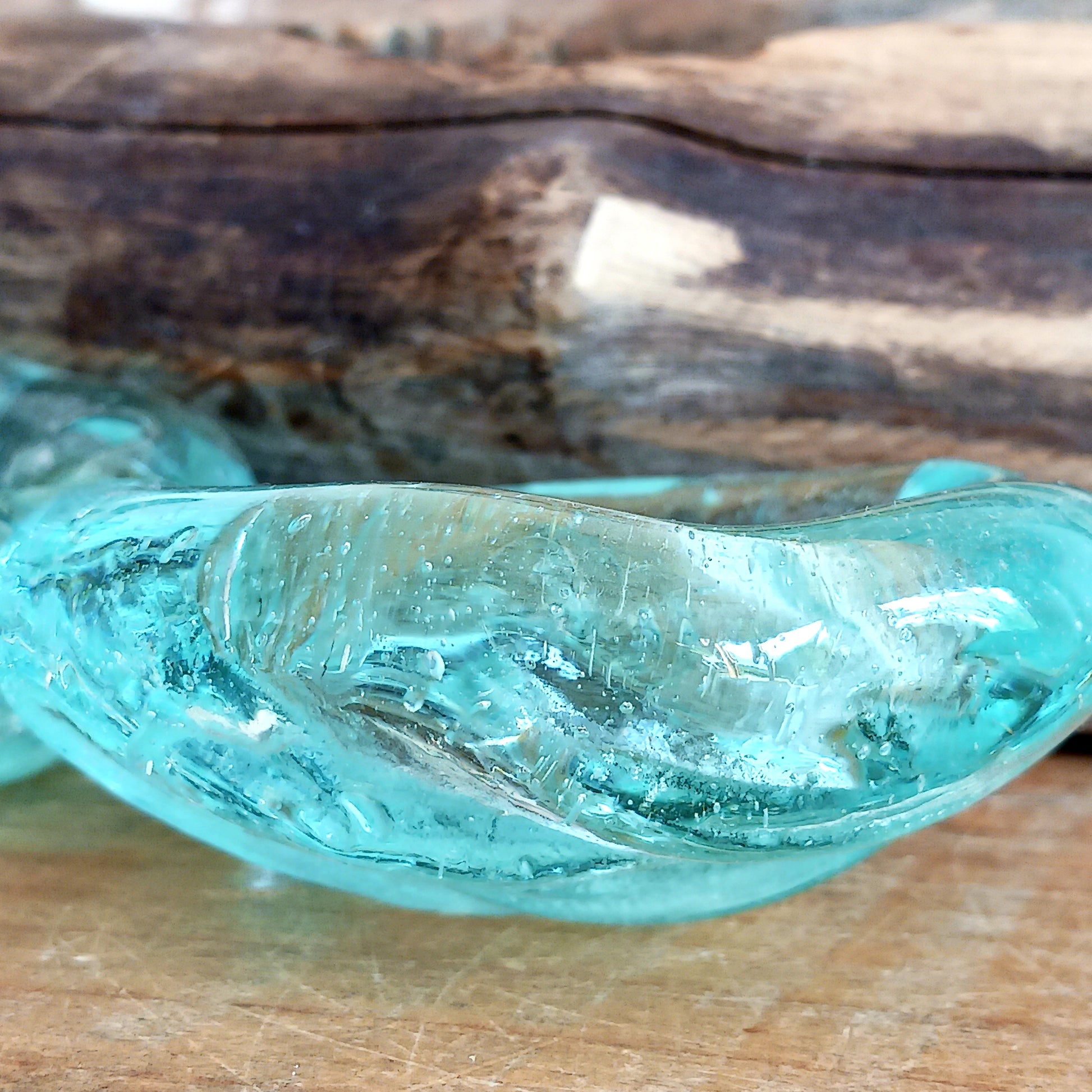 Bring nature into your home with this stunning handmade melted glass candle holder crafted in Bali. Each piece is truly one-of-a-kind, made from recycled glass hand-blown over whitewashed Balinese Gamal wood. As the molten glass cools, it moulds perfectly to the shape of the natural wood root, creating a unique balance of earthy and chic design. 