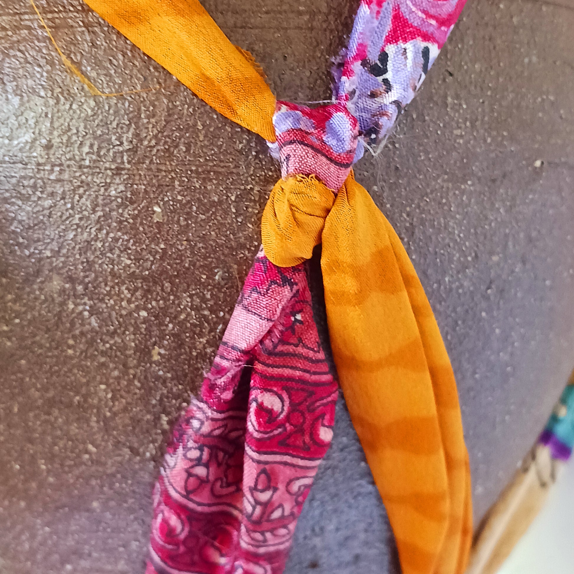 Add a burst of colour and a touch of boho charm to your home with these beautiful Large Recycled Sari Plant Hangers. Each hanger is handcrafted from upcycled sari fabric, giving new life to discarded textiles while ensuring no material goes to waste. Their simple yet elegant design allows them to complement any décor style, from minimal to eclectic. Featuring a sturdy metal ring for easy hanging, they are perfect for showcasing your favourite indoor plants in a sustainable and stylish way.