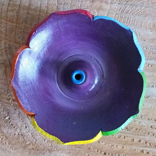 Bring serenity and spiritual balance into your space with this Hand Painted Tibetan Lotus Incense Holder. Lovingly crafted in Nepal by skilled artisans, this incense burner is made from natural wood and beautifully painted in the seven chakra colours, symbolizing harmony and enlightenment.