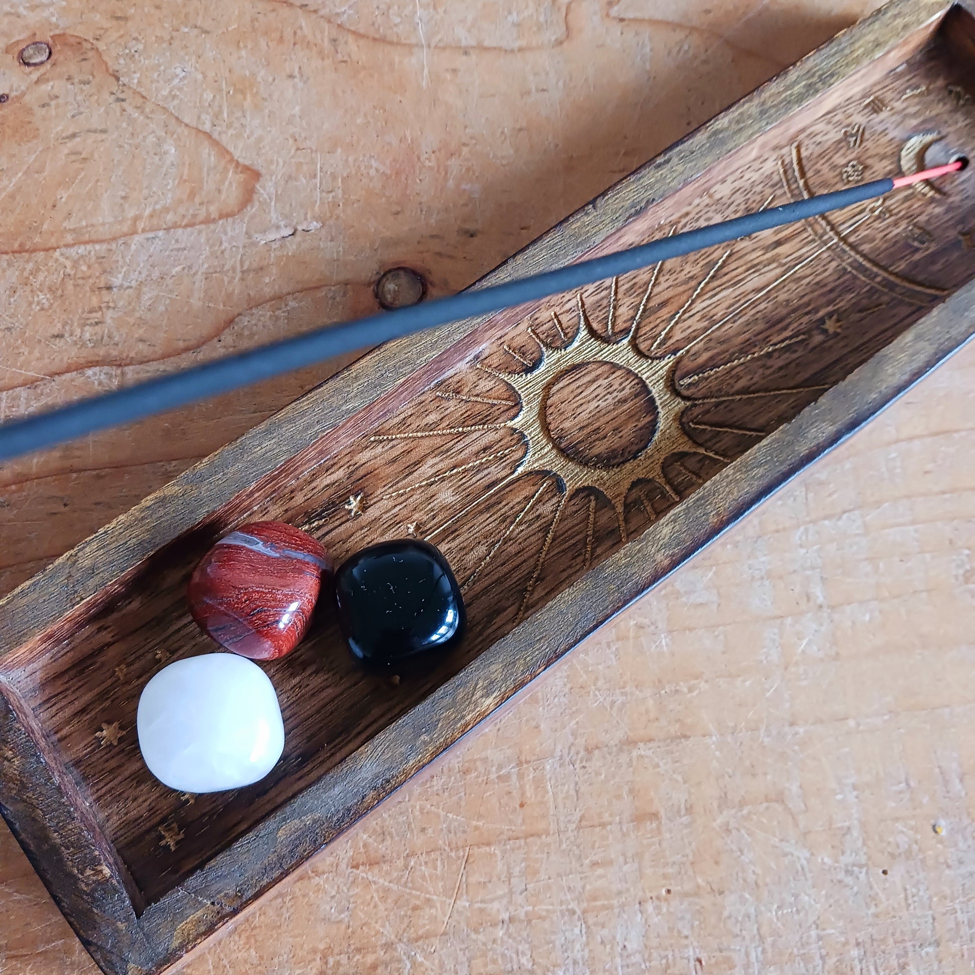 This Zodiac Incense Holder and Crystal Tray is a beautifully crafted ritual accessory made from natural mango wood and finished with gold-stamped astrological symbolism. Designed to hold incense sticks while offering a dedicated tray space for crystals or ritual objects, it brings structure and intention to daily practice.