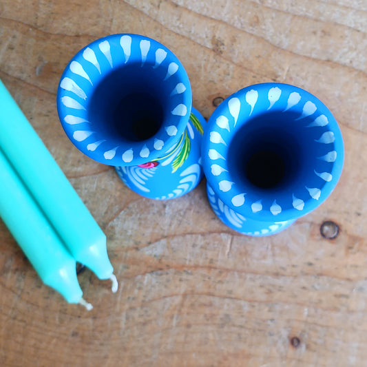 Hand painted in a vibrant blue hue and adorned with the Shapla (waterlily) flower — the national flower of Bangladesh, this fair trade candle holder is a true statement piece. Display it prominently or gift it to someone special as a unique, ethical, and meaningful present. Beautiful on its own or paired with others, it adds warmth, tradition, and cheerful design to any space.