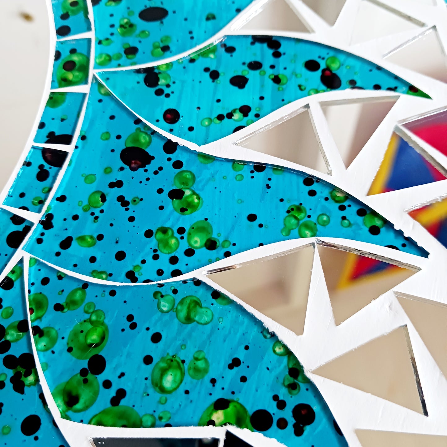 Add warmth, energy, and artistic charm to your home with this beautiful Vibrant Turquoise Mosaic Sun Mirror. Designed with dazzling turquoise mosaic tiles arranged in a radiant sunburst pattern, this captivating wall accent instantly brightens any room. 