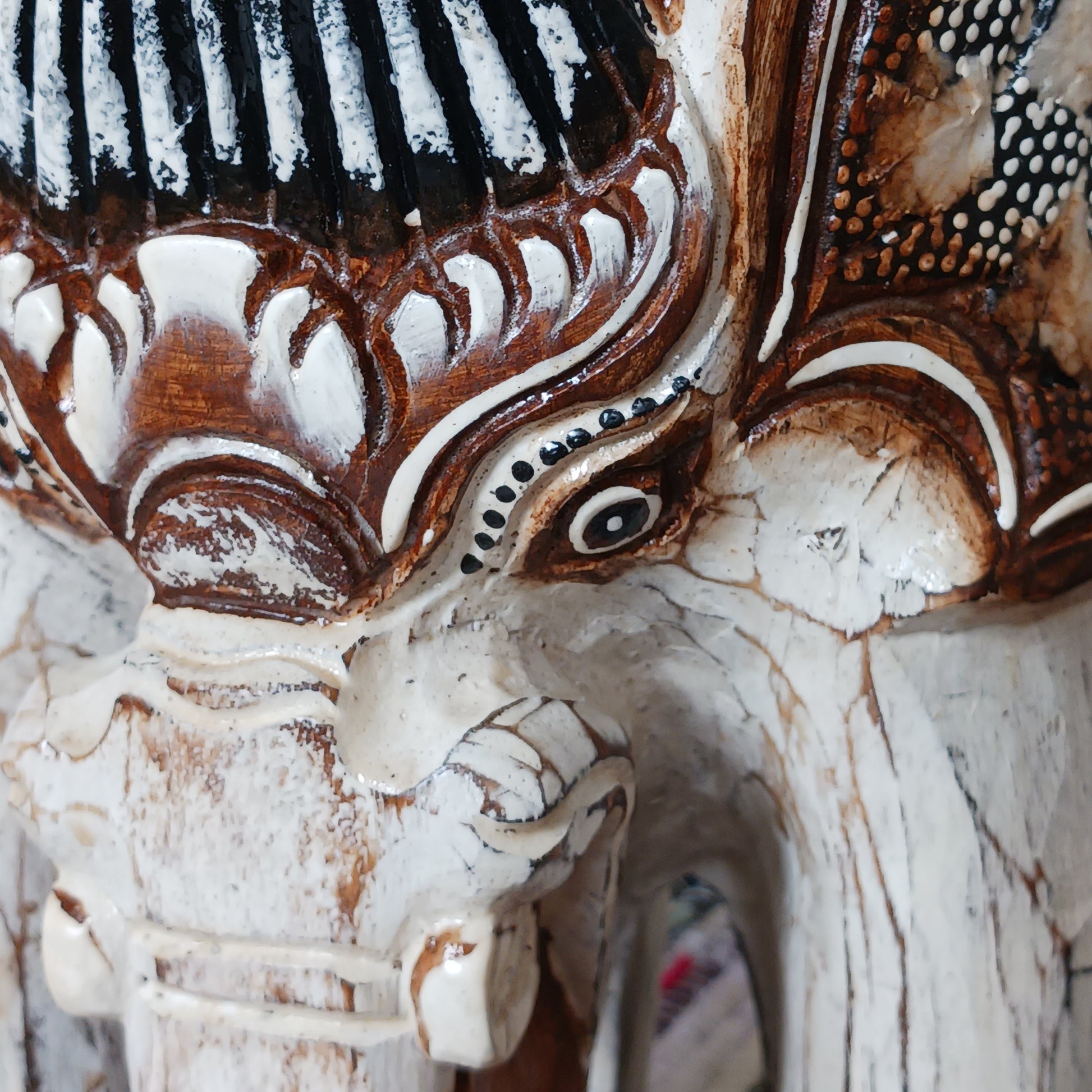 Hand carved from ableisa wood, this stunning elephant makes a great side table, coffee table. plant table or stool. This beautiful elephant piece is handmade and painted by artisans who have strong roots in storytelling and artwork that spans generations - this elephant is the perfect example!