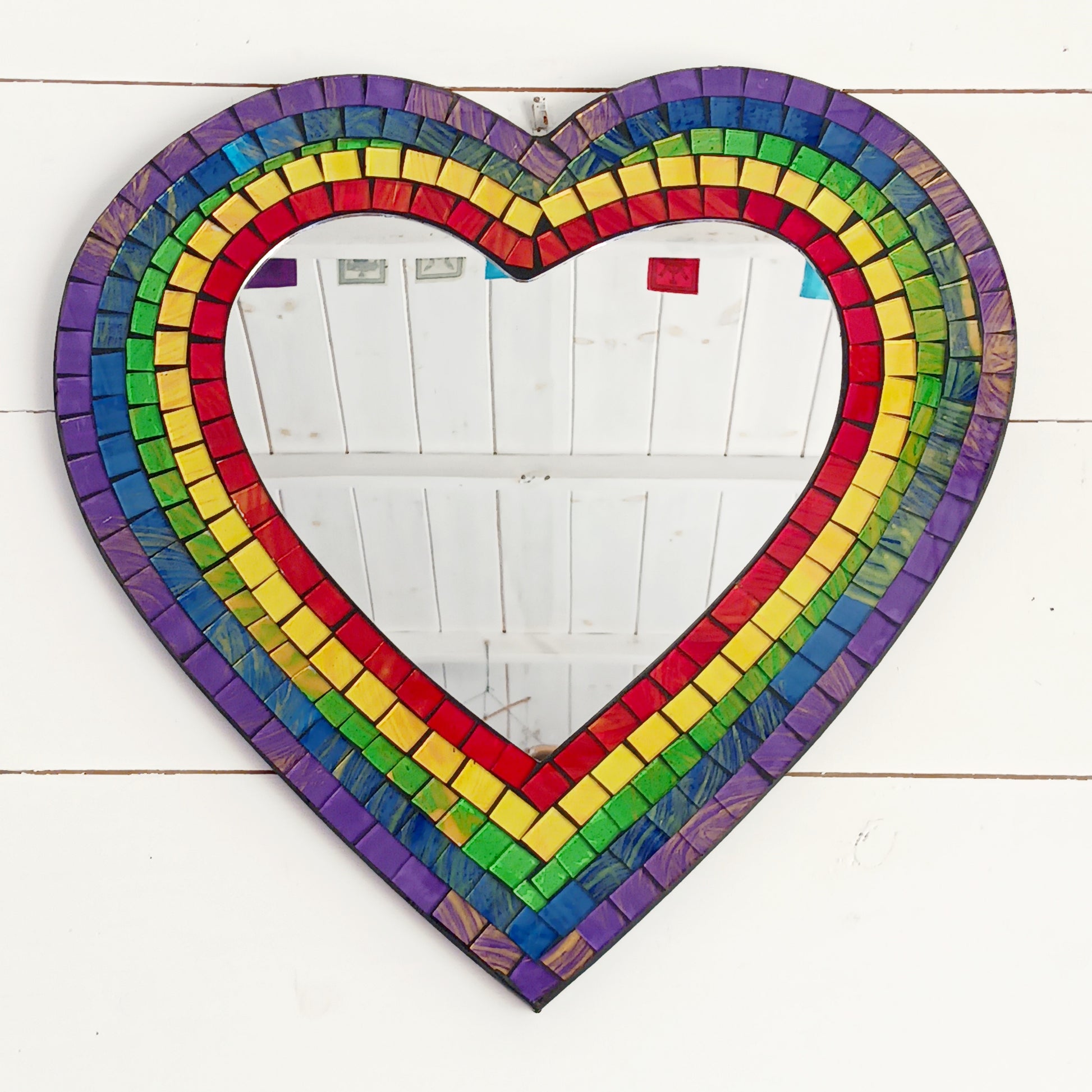 Decorate your home with a Rainbow Mosaic Heart Wall Mirror. A colourful decorative mirror perfect for bedrooms, living rooms, nurseries and unique gifts.
