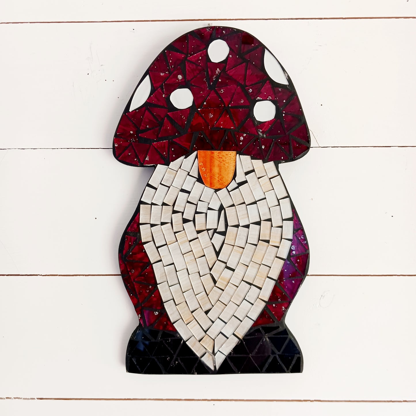 Bring personality and charm to your home with this Handcrafted Red Mosaic Gnome Wall Plaque. Featuring a delightful gnome design created with vibrant red mosaic tiles, this unique wall decoration adds a playful touch to any living space.