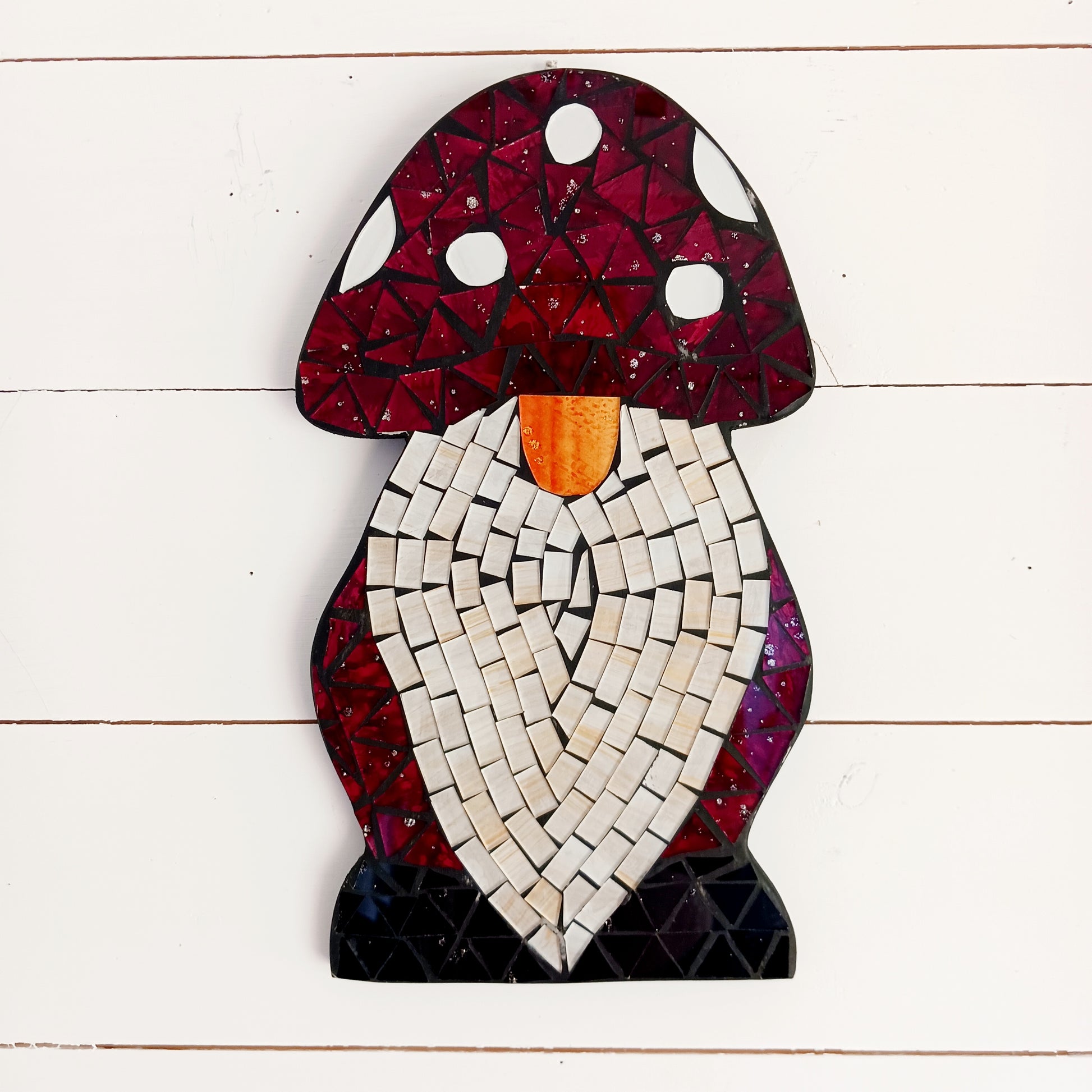 Bring personality and charm to your home with this Handcrafted Red Mosaic Gnome Wall Plaque. Featuring a delightful gnome design created with vibrant red mosaic tiles, this unique wall decoration adds a playful touch to any living space.