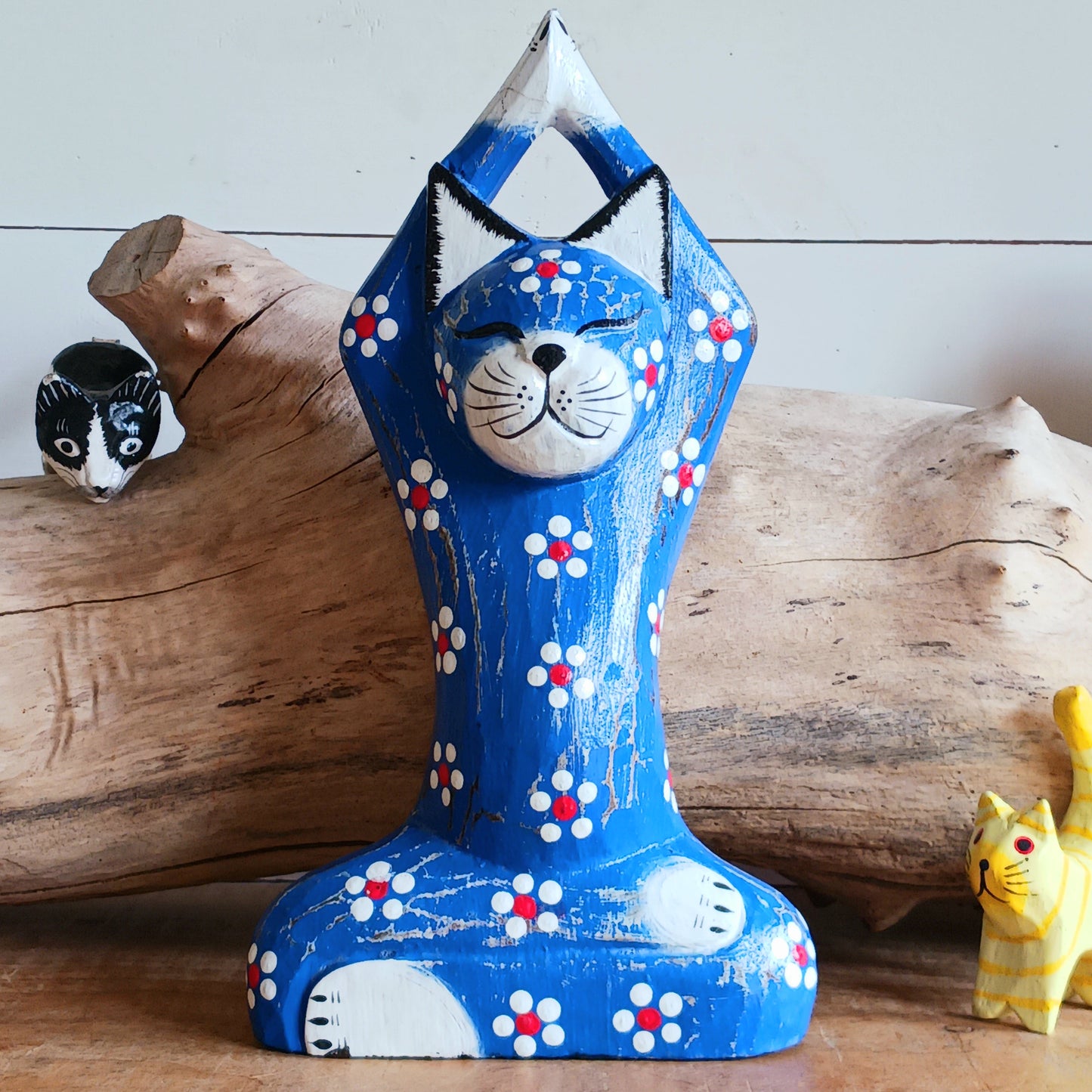 Bring serenity and mindfulness into your home with this beautifully handcrafted Blue Yogi Cat Statue. Designed in a peaceful prayer yoga pose and adorned with delicate floral details, this charming decorative piece inspires relaxation, balance, and positive energy.