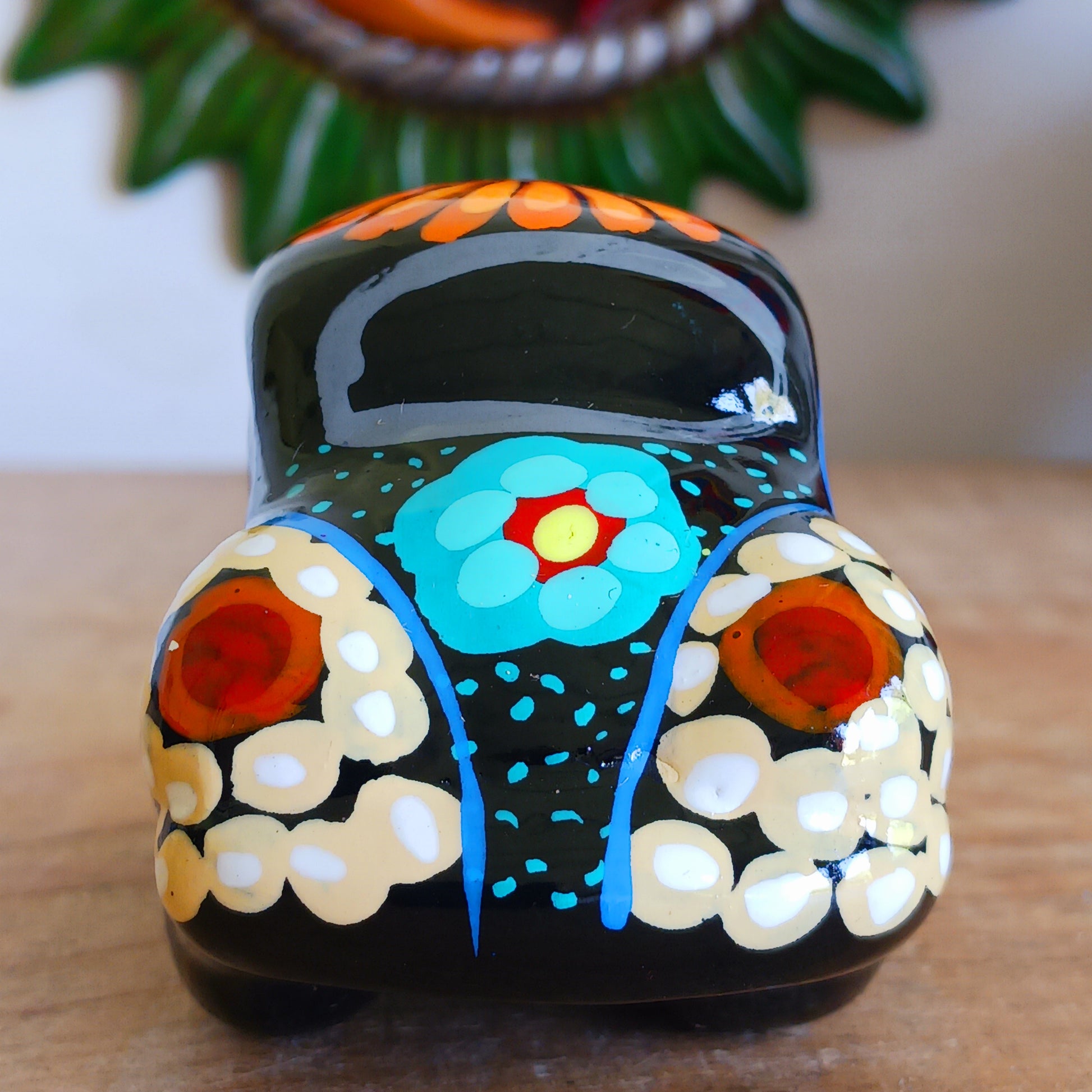 This fun little VW car ornament oozes retro vibes.  With it's bold flower power design and vibrant colours it will brighten up any sideboard.  This type of car, affectionately known as a 'bochito', are very popular in Mexico due to their reliability when driving about steep roads. Incidentally, the Mexican town of Puebla was home to the last Beetle production factory which only closed in 2003.