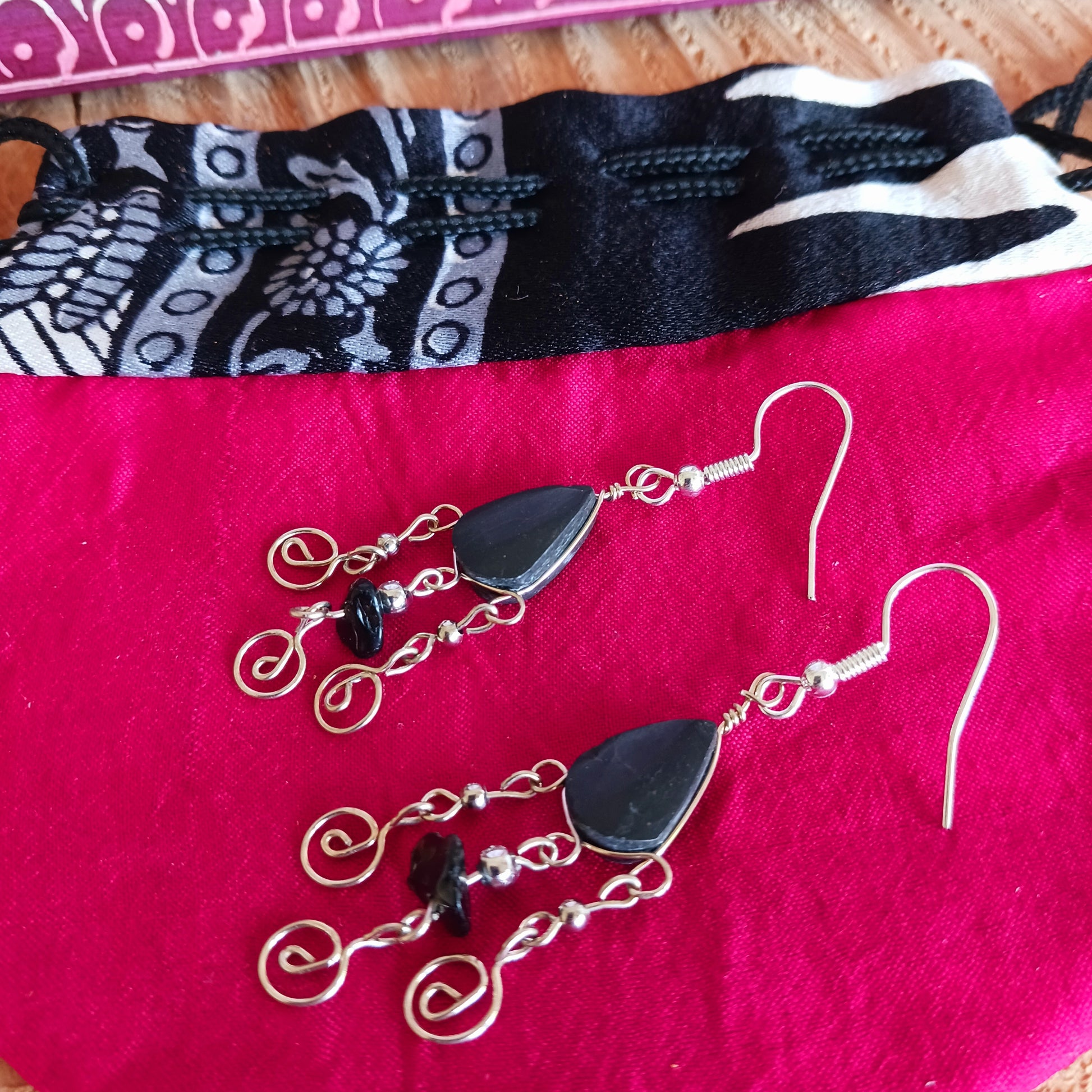 These beautiful spiral earrings feature a turquoise stone and three spirals. They dangle really nicely when worn, and are easy to dress up or down. The hooks are made from sterling silver.