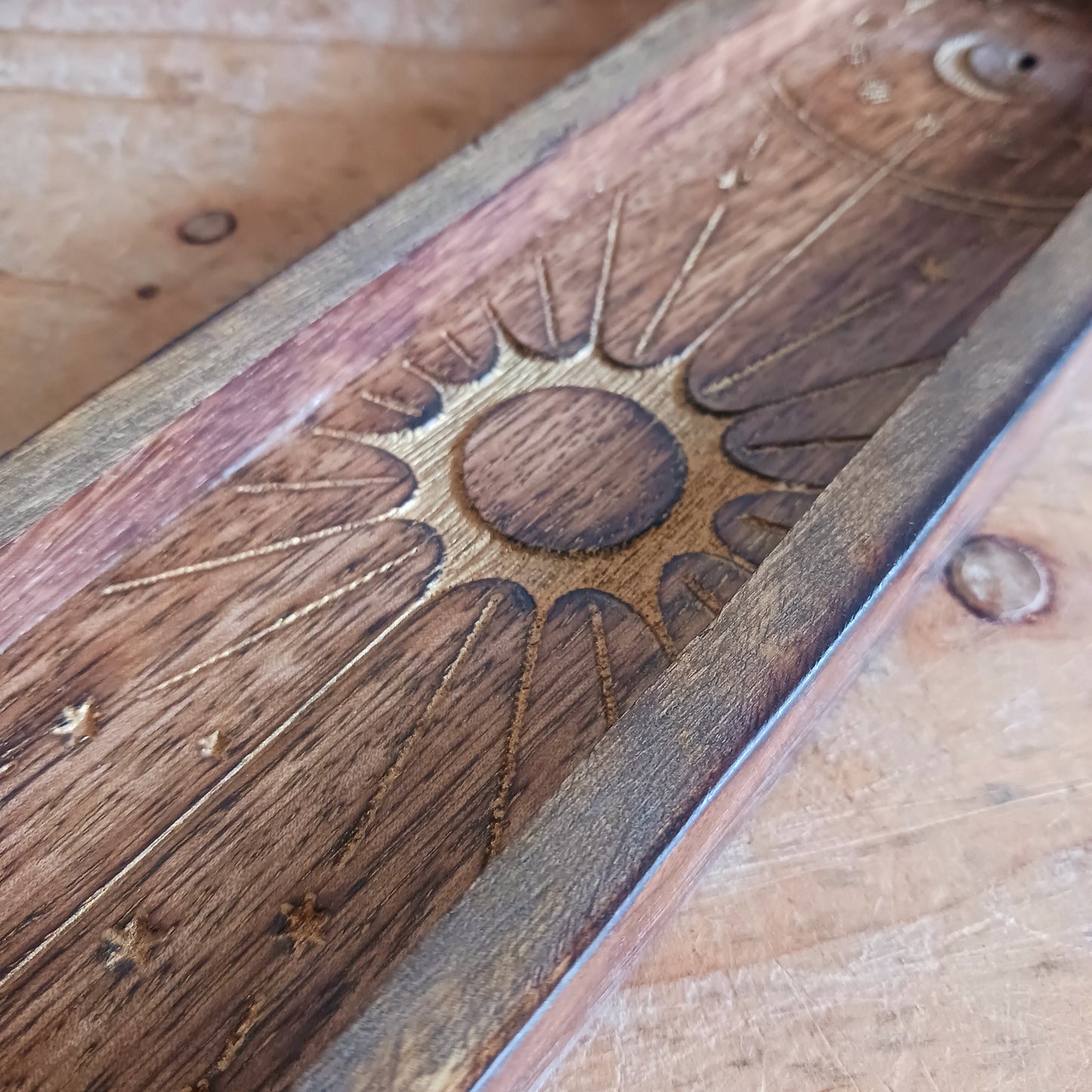 This Zodiac Incense Holder and Crystal Tray is a beautifully crafted ritual accessory made from natural mango wood and finished with gold-stamped astrological symbolism. Designed to hold incense sticks while offering a dedicated tray space for crystals or ritual objects, it brings structure and intention to daily practice.