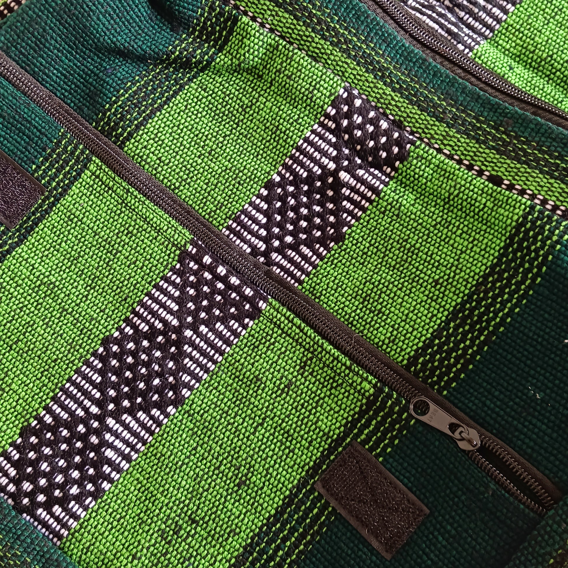Inspired by the Spanish word for "colourful," this Vistoso Satchel brings vibrant style and practical design together. Available in a variety of bold and eye-catching patterns, this satchel comes in lovely shades of green and is both fashionable and functional. The spacious main zipped compartment comfortably fits a small laptop or notebook, while the additional front zipped pocket keeps essentials within easy reach.