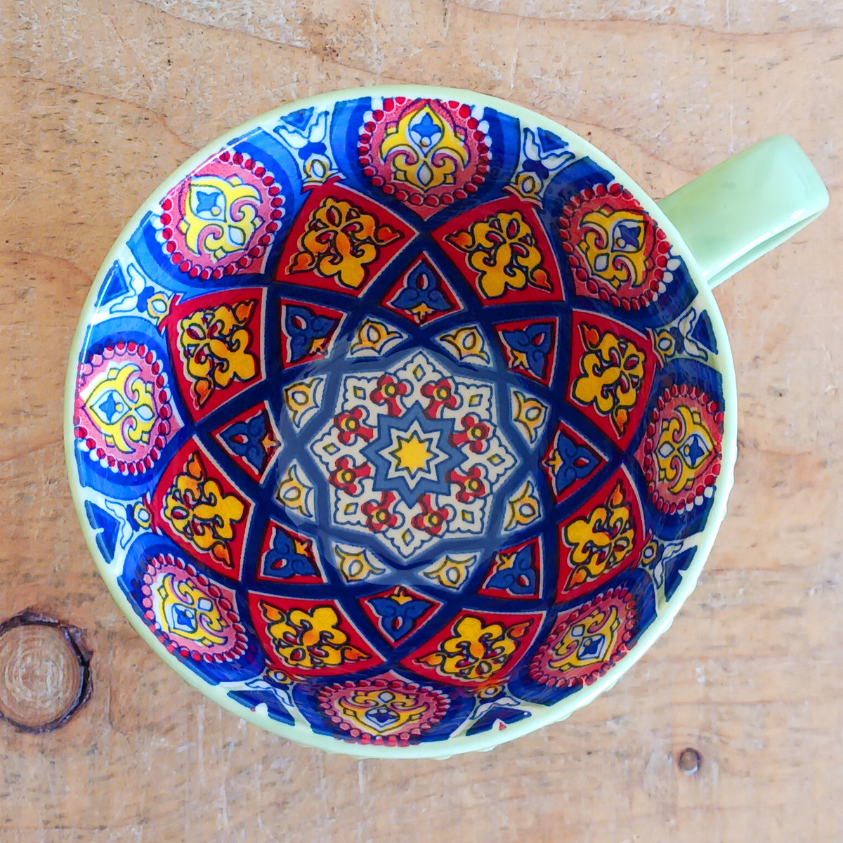 Bring the warmth and colour of the Mediterranean into your home with this beautiful Tuscany-inspired ceramic mug. Featuring a vibrant glazed exterior and an eye-catching embossed geometric pattern inside, this stylish mug is inspired by the rustic terracotta tiles and intricate murals found in sun-soaked Italian villages.