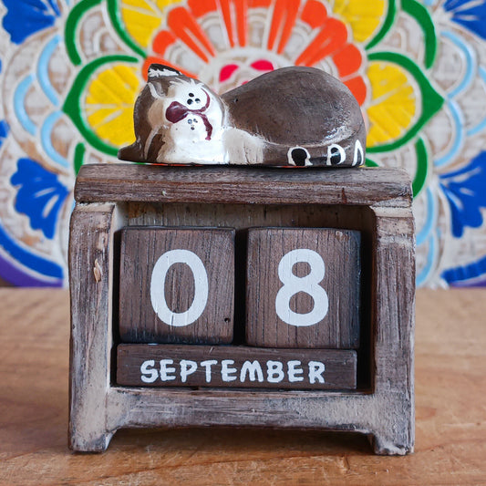 Add a touch of cuteness and inspiration to your space with this Sleeping Cat Wooden Calendar. Featuring reusable number blocks, this perpetual calendar ensures you’ll never need to buy another one again. Perfect for desks, shelves, or bedside tables, it’s both practical and charming—bringing daily motivation and a cozy aesthetic to any room.