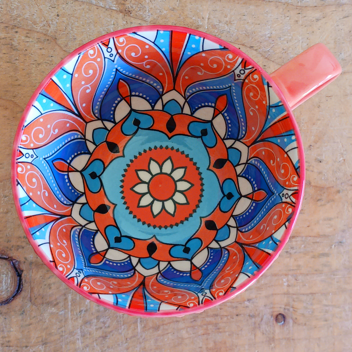 Bring the warmth and colour of the Mediterranean into your home with this beautiful Tuscany-inspired ceramic mug. Featuring a vibrant glazed exterior and an eye-catching embossed geometric pattern inside, this stylish mug is inspired by the rustic terracotta tiles and intricate murals found in sun-soaked Italian villages.