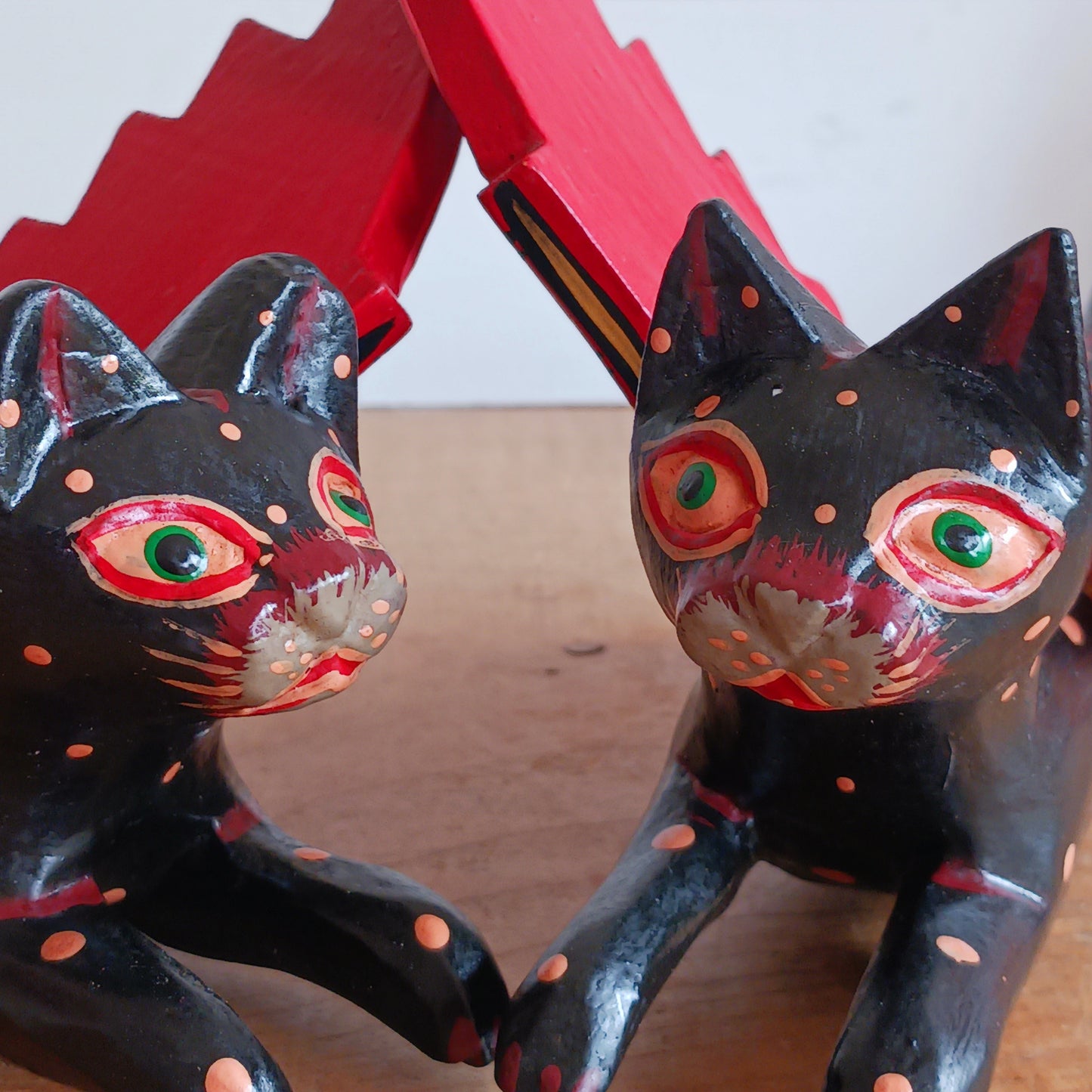 Bring a touch of mystery and magical drama to your home with this striking flying cat mobile, hand carved and painted by skilled artisans in Bali. Featuring a deep black cat with vivid red wings and intricate painted detailing, this unusual hanging decoration makes a bold statement wherever it is displayed.