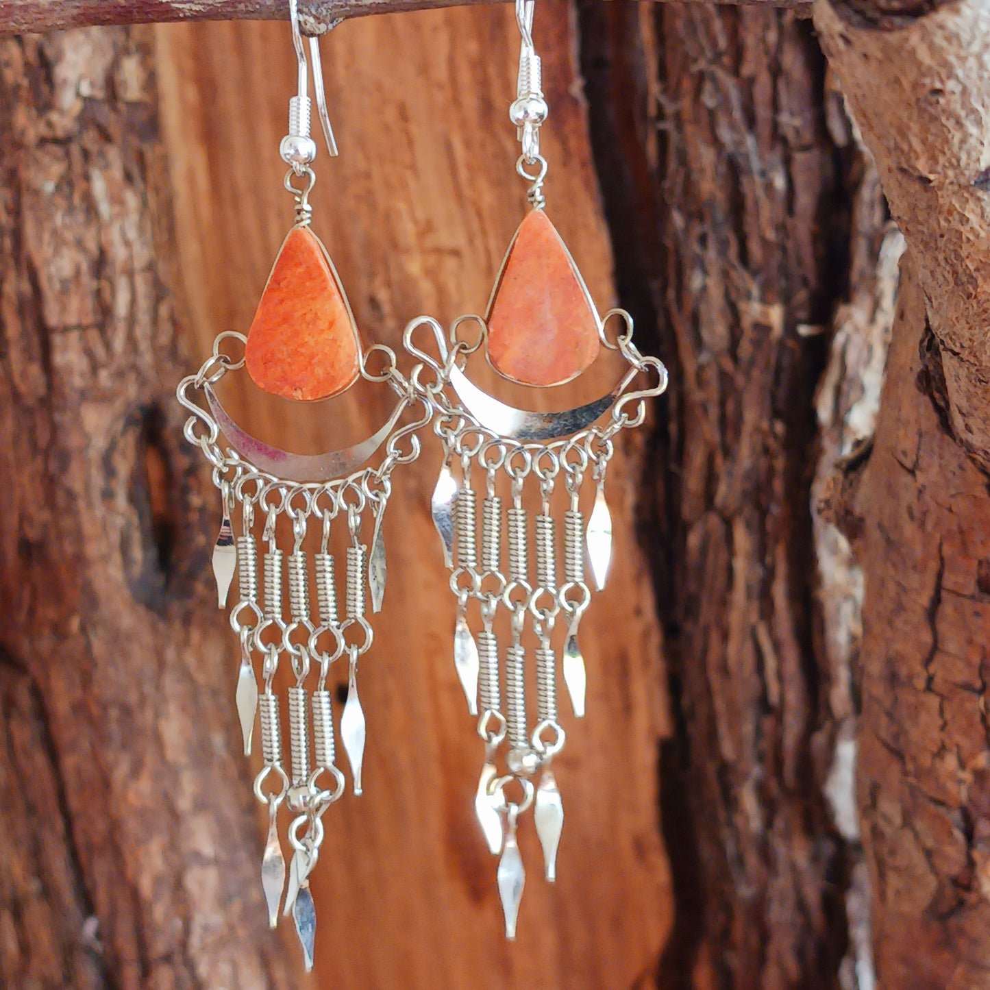 Add a touch of bohemian beauty to your look with these handmade Peruvian stone earrings. Featuring orange stones and finished with silver-plated hooks, each pair is carefully crafted in small workshops in Peru.