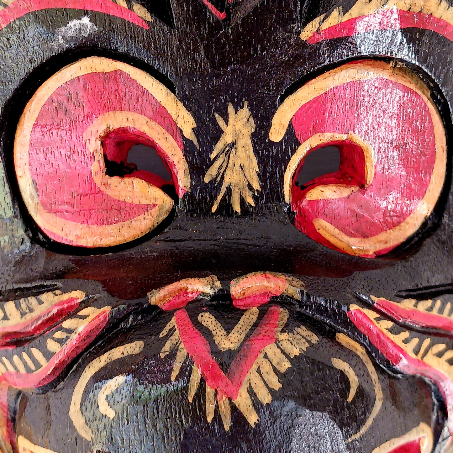 This hand carved and hand painted mask depicts Hanuman, the monkey god. He is integral to the Hindu tale of Ramayana, aiding Rama in the heroic rescue of his wife Sita.
