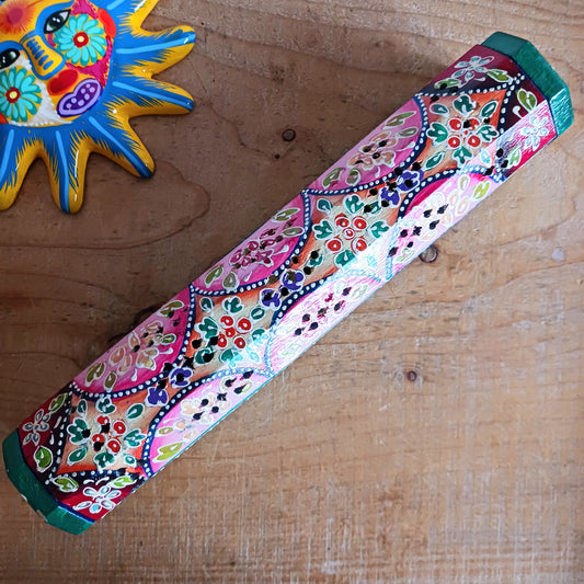 This beautiful pink and green wooden Incense box has been hand painted and has a curved hinged lid. It can accommodate both incense sticks and cones. There is also a place for you to safely store your incense sticks at the bottom on the box.