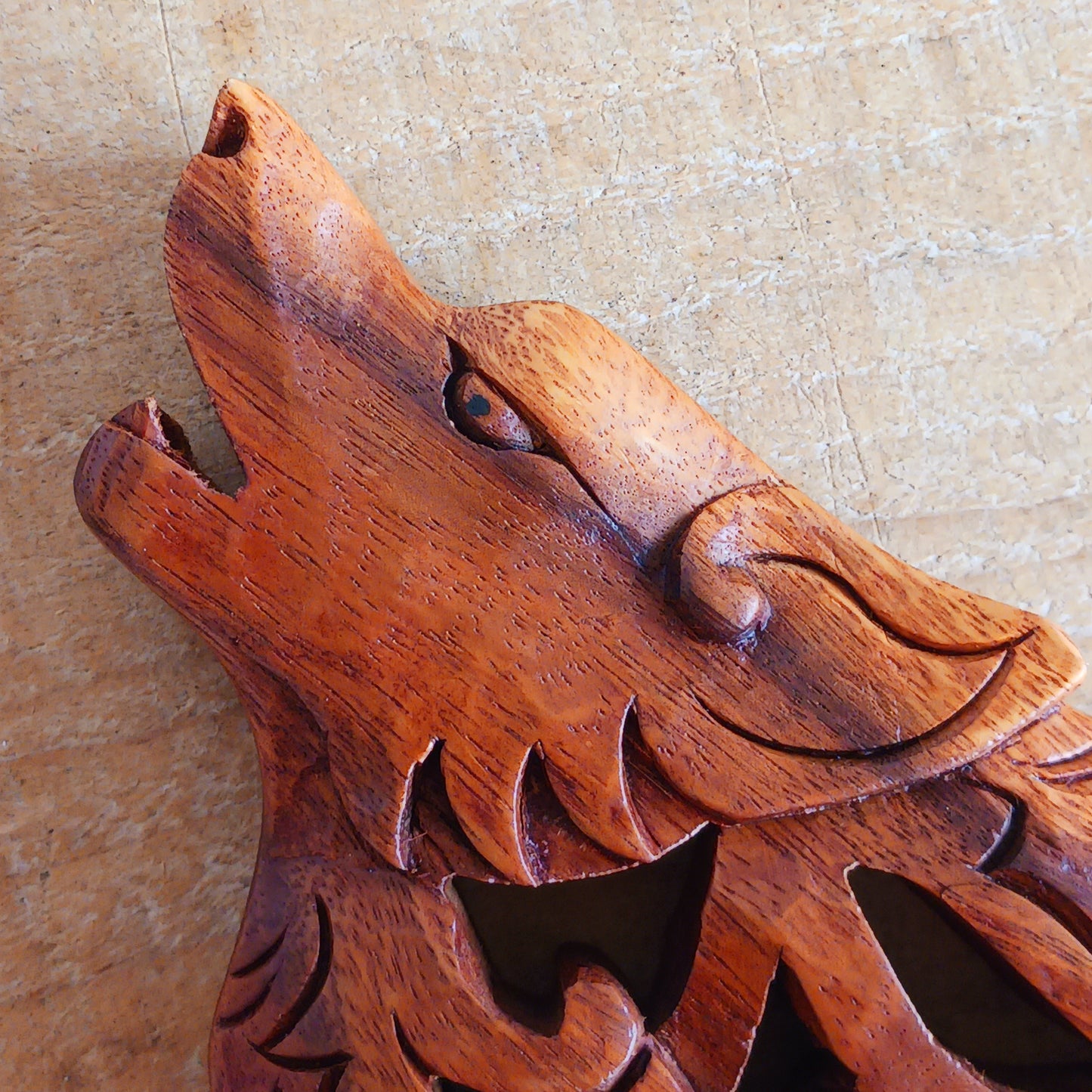 Bring the spirit of the wild into your home with this beautiful and striking Howling Wolf Celtic Knotwork Wooden Plaque. Hand-carved by skilled artisans in Bali, this open-work wooden wall plaque features an upright wolf with its head thrown back in a powerful howl.