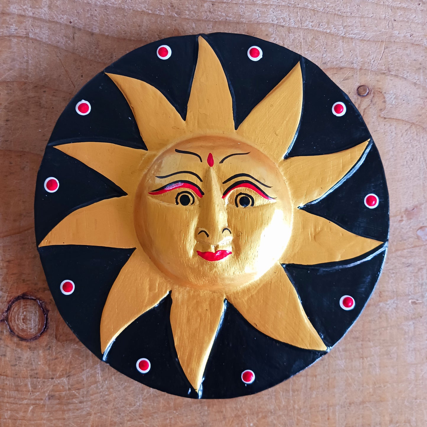 Bring a burst of sunshine into your home with this Black and Gold Sun Plaque, lovingly hand-carved in Bali from sustainably sourced wood. Each plaque features a radiant sun face surrounded by detailed rays, symbolizing warmth, vitality, and the cycles of life.