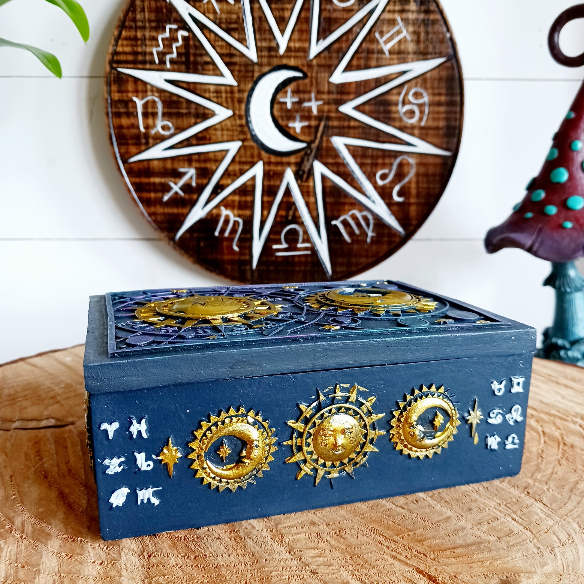 This unusual decorated resin box has raised astrology symbols and a detailed sun and moon design with a gold finish. 
 This celestial style is perfect for holding trinkets, crystals and other small objects for safe keeping.