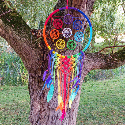Bring harmony, colour, and positive energy into your space with this large, vibrant dreamcatcher. Featuring seven small hoops representing each of the chakras, this stunning piece is hand-crafted with bright rainbow crocheting. Ideal as a wall hanging, it makes a thoughtful gift for yoga lovers, meditation enthusiasts, or anyone seeking balance and wellbeing. Perfect for adding a spiritual touch to your home décor while promoting peace and positivity.