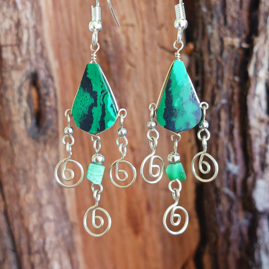 These beautiful spiral earrings feature a turquoise stone and three spirals. They dangle really nicely when worn, and are easy to dress up or down. The hooks are made from sterling silver.