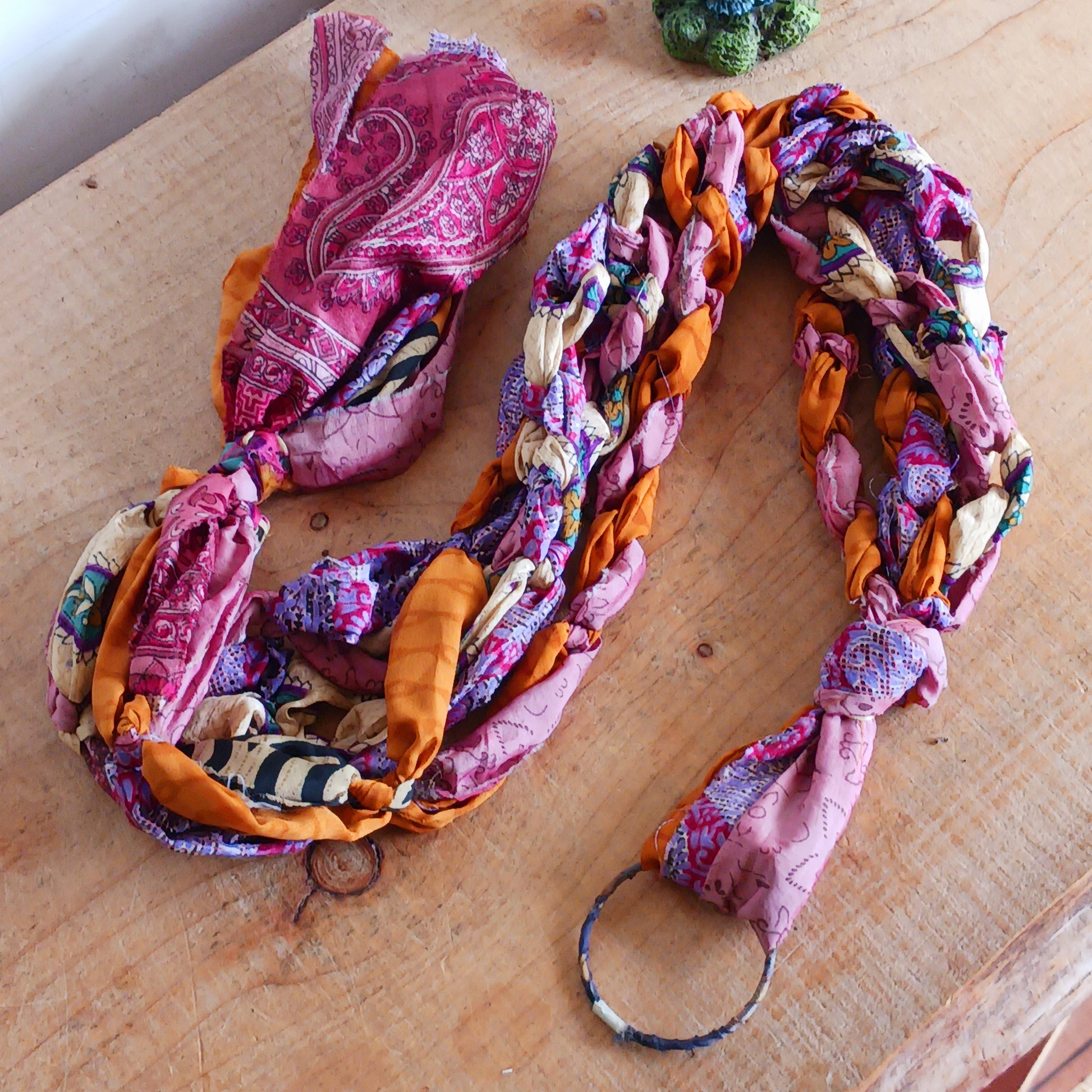 Add a burst of colour and a touch of boho charm to your home with these beautiful Large Recycled Sari Plant Hangers. Each hanger is handcrafted from upcycled sari fabric, giving new life to discarded textiles while ensuring no material goes to waste. Their simple yet elegant design allows them to complement any décor style, from minimal to eclectic. Featuring a sturdy metal ring for easy hanging, they are perfect for showcasing your favourite indoor plants in a sustainable and stylish way.