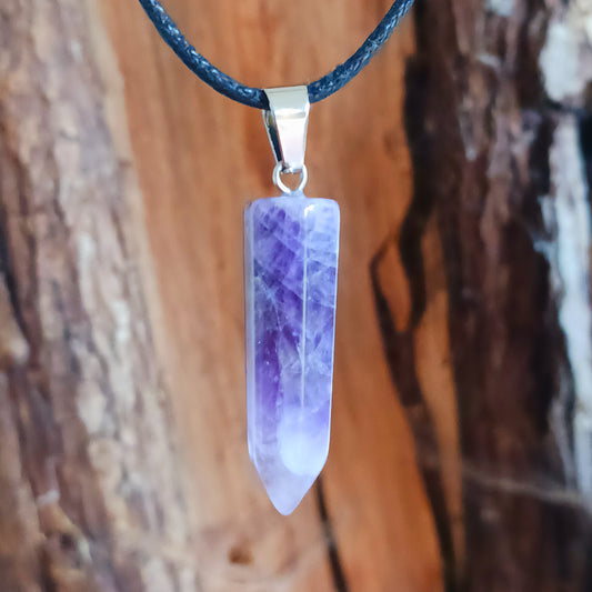 Elevate your style and energy with this stunning Amethyst Crystal Pendant Necklace. Featuring a natural amethyst crystal on a sleek black cord, this piece is both a beautiful accessory and a powerful spiritual tool. Amethyst, known as the stone of spirituality and peace, ranges in shades from soft lavender to deep violet.