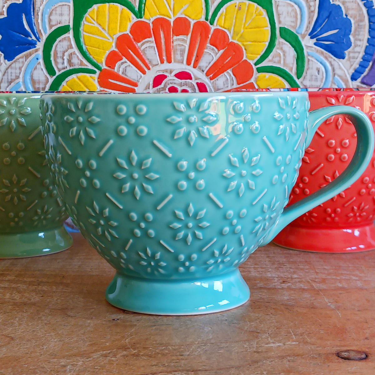 Bring the warmth and colour of the Mediterranean into your home with this beautiful Tuscany-inspired ceramic mug. Featuring a vibrant glazed exterior and an eye-catching embossed geometric pattern inside, this stylish mug is inspired by the rustic terracotta tiles and intricate murals found in sun-soaked Italian villages.